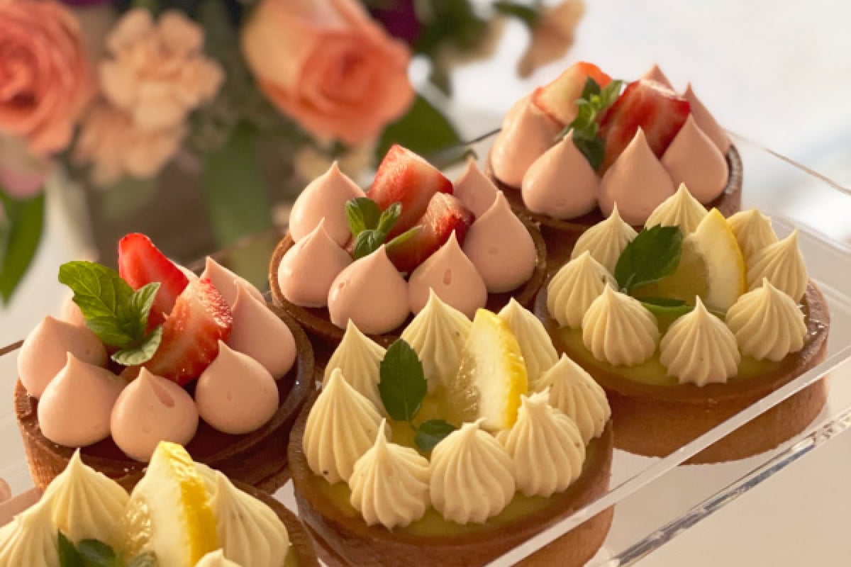 Handcrafted fruit tarts with berries and cream at Fox Bakery